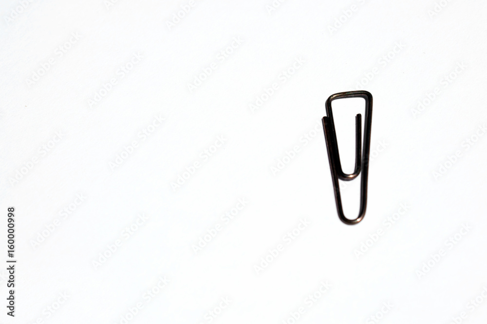Paper Clip isolated on white background. Closeup shot. Paper Clip isolated on white background. Closeup shot.
