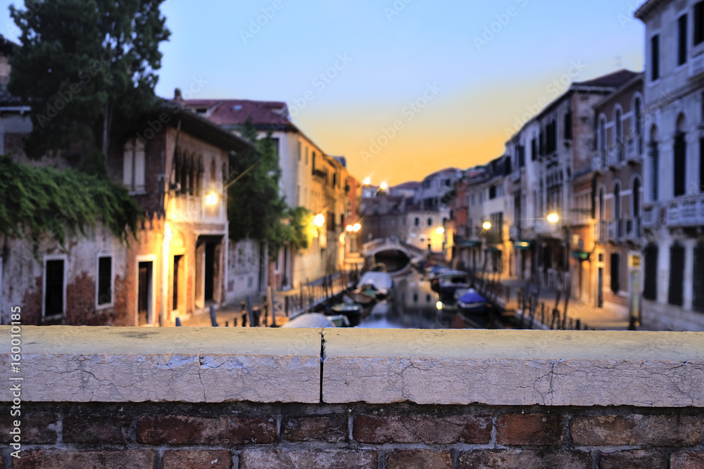 Venice, Italy, May, 31, 2017: night landscape with the image of  channel in Venice, Italy with bridge parapet under the frontground. Focus is under the parapet