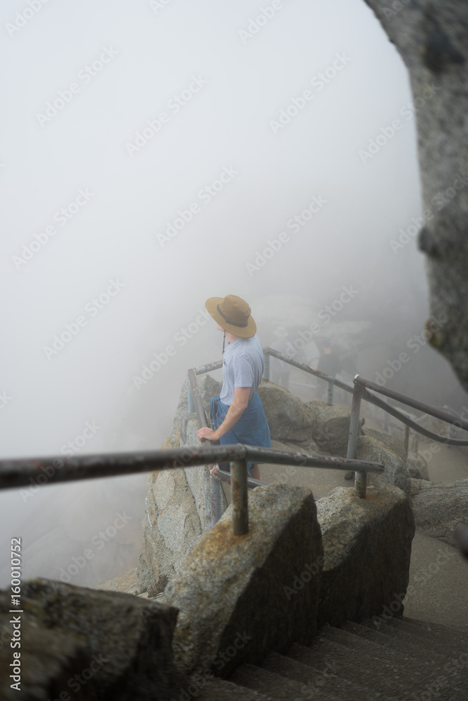 Lone Adventurer Takes in a Foggy Morning View