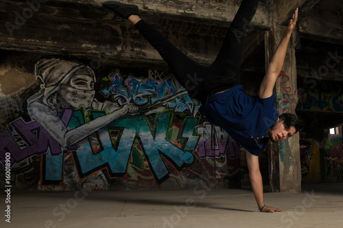 Young male dancer doing a handstand