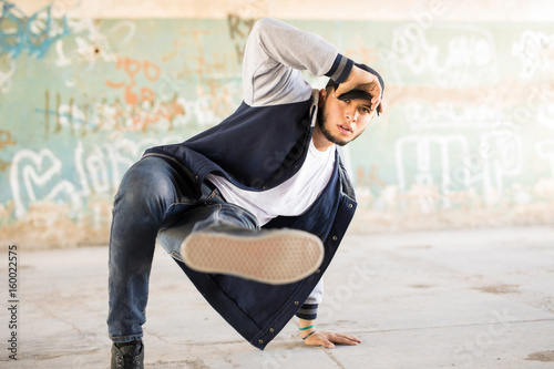 Young man breakdancing outdoors