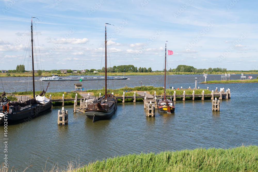 Boats in historic harbour of fortified town of Woudrichem, Netherlands