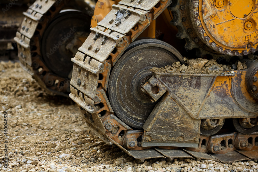 The Crawler close up , muddy crawler chain detail in earthy ambiance, Well used excavator tracks closeup