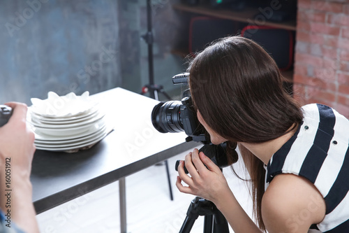 Young woman taking photo of...