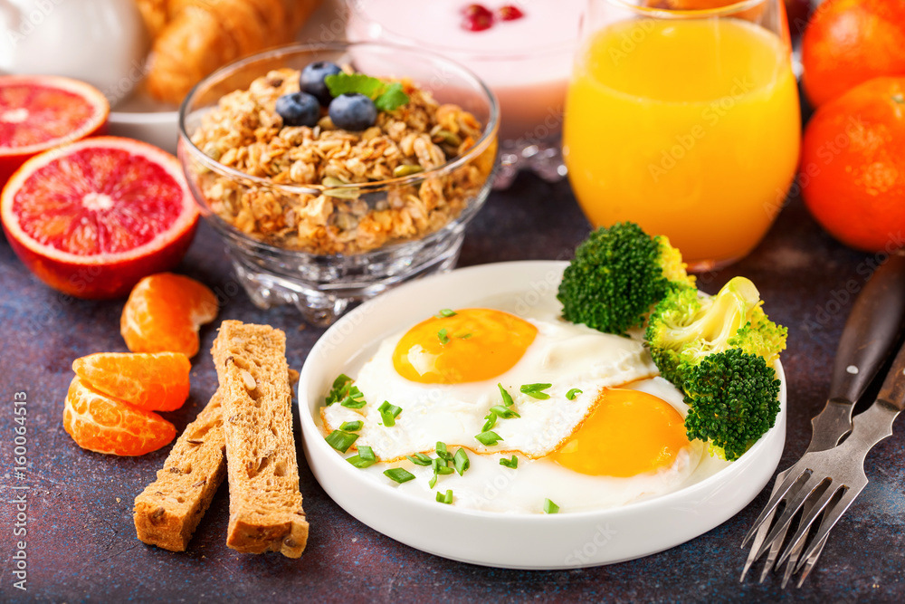 Breakfast - fried eggs with broccoli, muesli, croissant and juice on a table. Selective focus. Copy space Breakfast - fried eggs with broccoli, muesli, croissant and juice on a table. Selective focus. Copy space