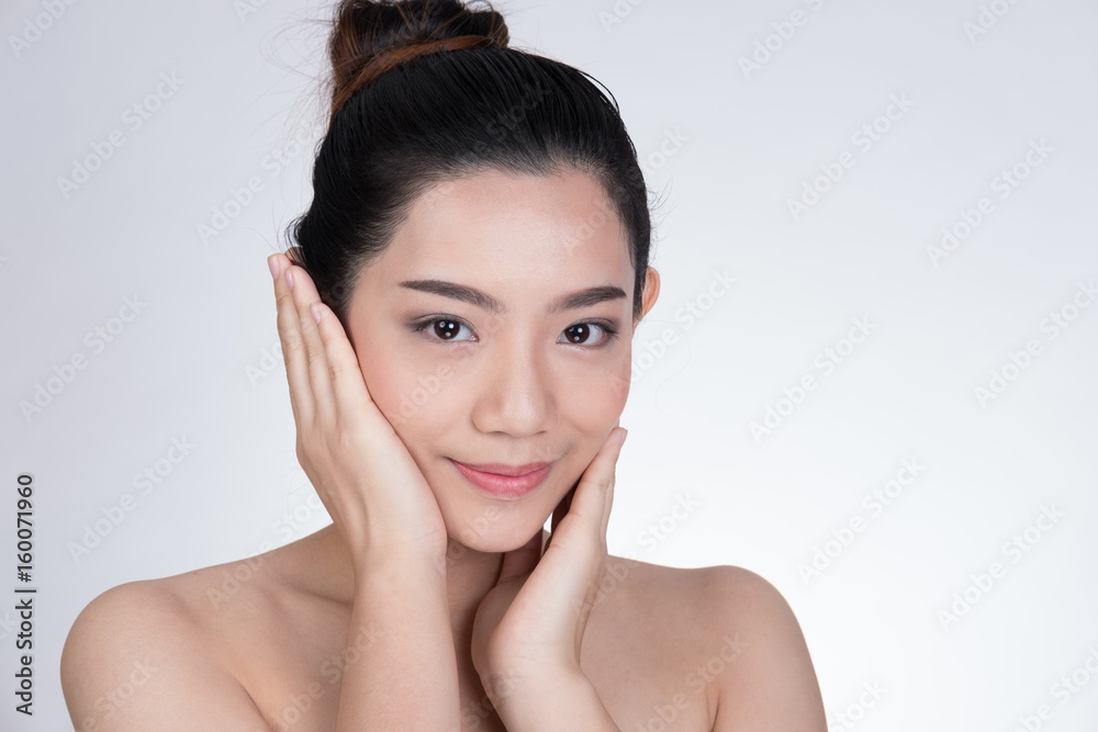 Portrait of a smiling young woman with natural make-up. beautiful asian girl standing against white background. Skincare, healthcare, studio shot. Portrait of a smiling young woman with natural make-up. beautiful asian girl standing against white background. Skincare, healthcare, studio shot.