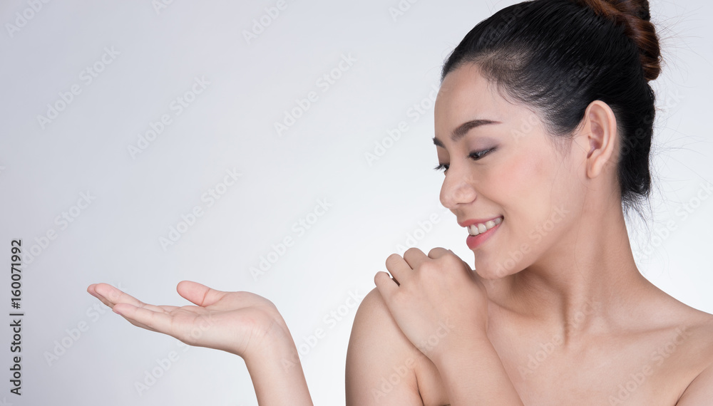 Portrait of a smiling young woman with natural make-up. beautiful asian girl standing against white background. Skincare, healthcare, studio shot. Portrait of a smiling young woman with natural make-up. beautiful asian girl standing against white background. Skincare, healthcare, studio shot.