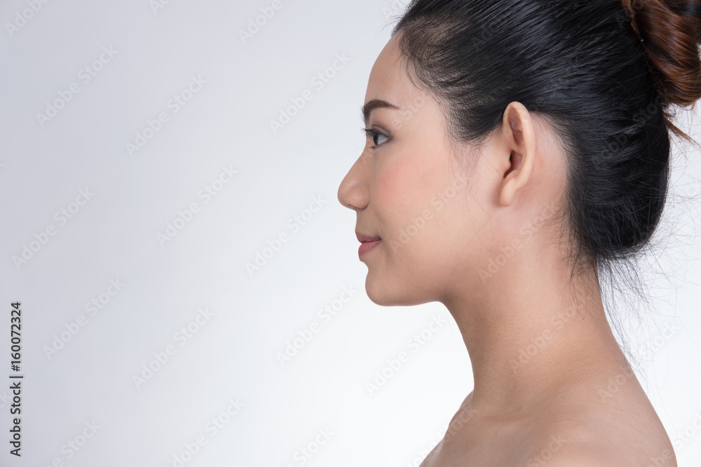 Portrait of a smiling young woman with natural make-up. beautiful asian girl standing against white background. Skincare, healthcare, studio shot. Portrait of a smiling young woman with natural make-up. beautiful asian girl standing against white background. Skincare, healthcare, studio shot.
