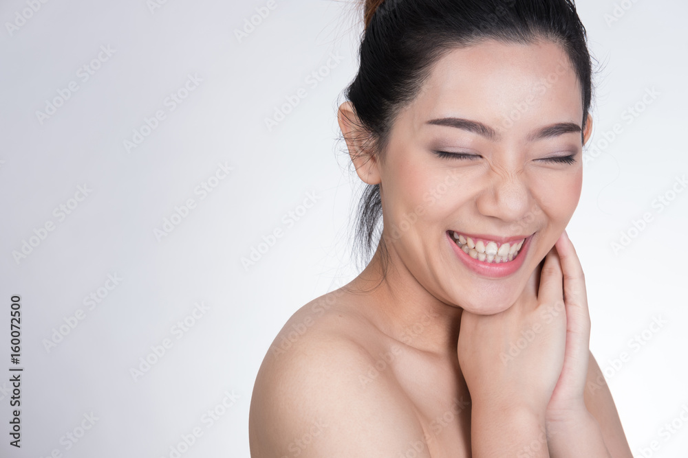 Portrait of a smiling young woman with natural make-up. beautiful asian girl standing against white background. Skincare, healthcare, studio shot. Portrait of a smiling young woman with natural make-up. beautiful asian girl standing against white background. Skincare, healthcare, studio shot.