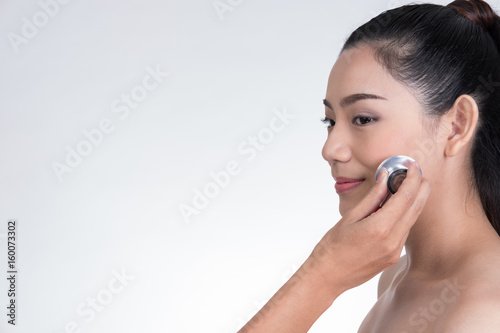 crazy doctor's hand holding stethoscope for checkup woman's face. Healthcare and medical concept