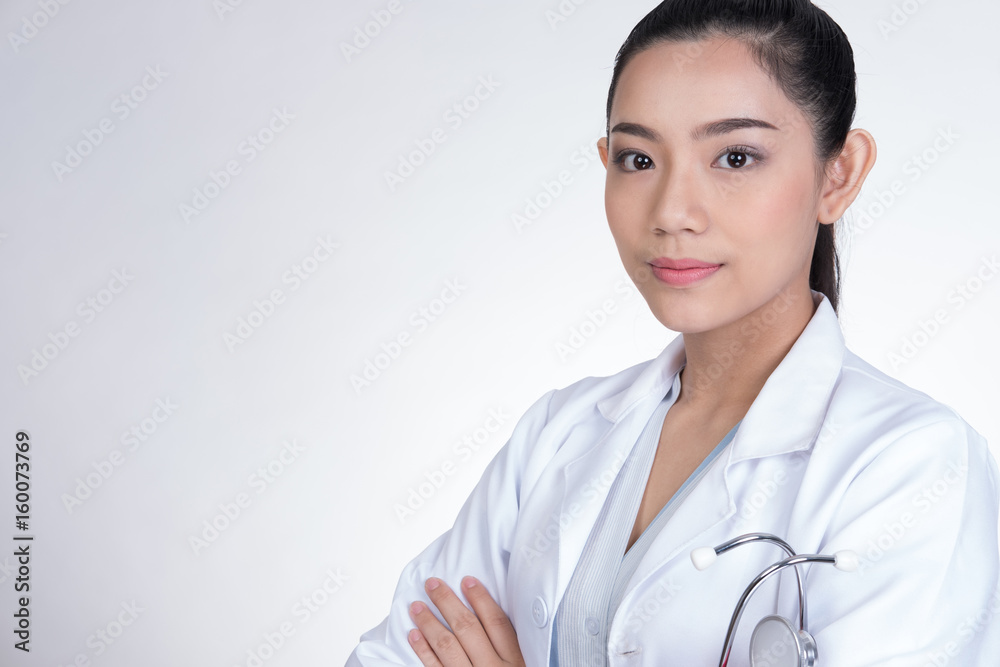 Confident smiling young female doctor posing with arms crossed. Portrait of medical staff, physician or practitioner on white background Confident smiling young female doctor posing with arms crossed. Portrait of medical staff, physician or practitioner on white background