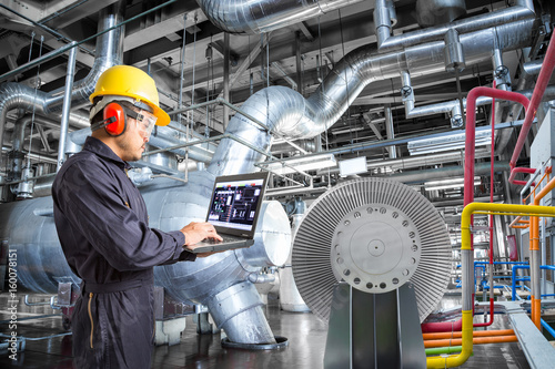 Obraz na plátně Engineer using laptop computer for maintenance in thermal power plant factory