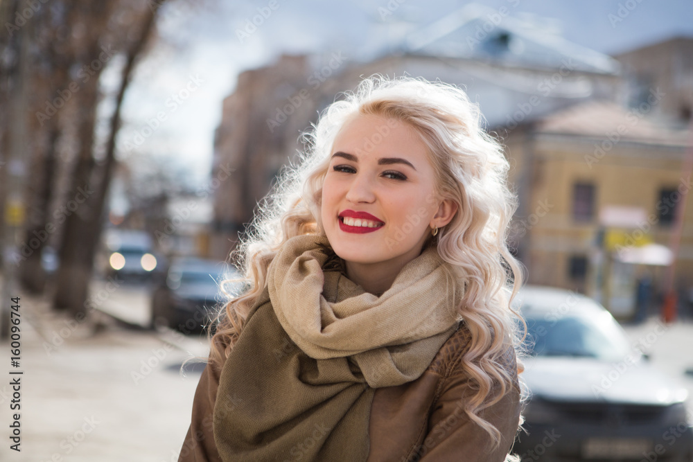 outdoor portrait of Girl cute funny positive. Sunny day. Portrait of an attractive blonde girl in the street. outdoor portrait of Girl cute funny positive. Sunny day. Portrait of an attractive blonde girl in the street.