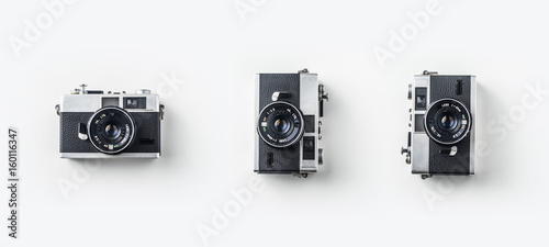 Принти на полотні Top view of vintage cameras on white background desk for mockup, collection of diverse angle