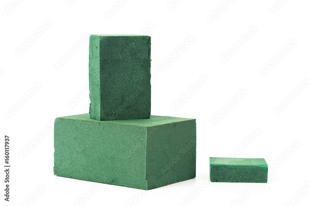 Green flora foam and gardener tool on white Green flora foam and gardener tool on white