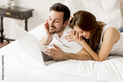 Young couple with laptop in...