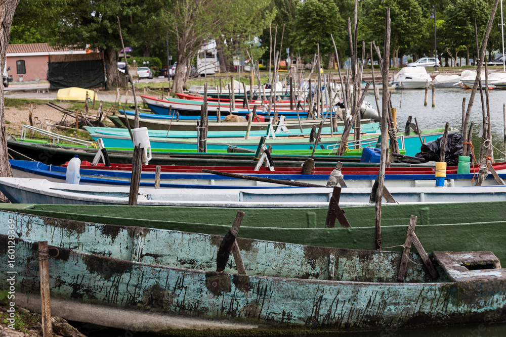 A view of many colorful, little fishing boats in a dock