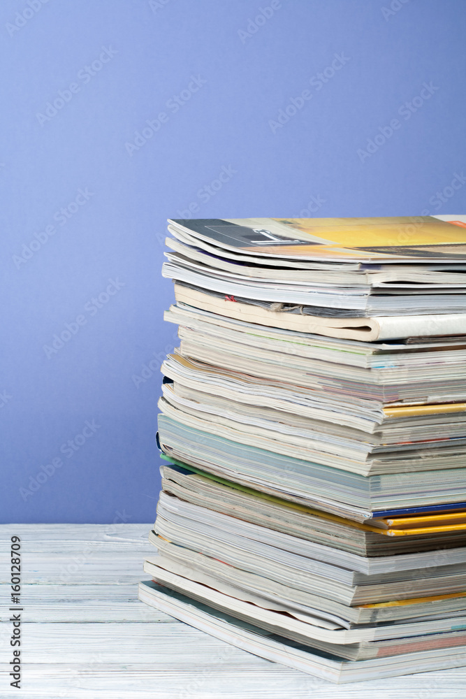 Open stacking book, hardback colorful books, magazine on wooden table and purple background. Back to school. Copy space for text. Education business concept. Open stacking book, hardback colorful books, magazine on wooden table and purple background. Back to school. Copy space for text. Education business concept.