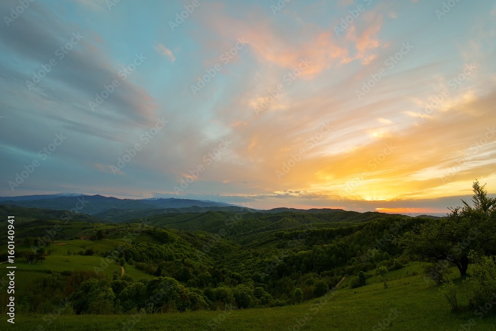 Evening and sunset on mountain hills of a romanian village