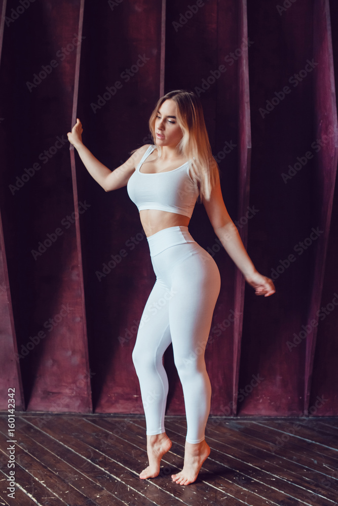 Sexy blonde woman with huge breast in a white top and leggings. Mock-up.  Photos | Adobe Stock