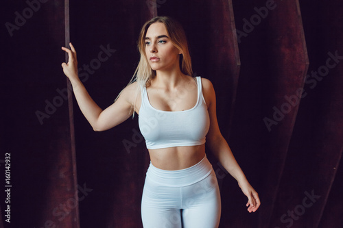 Sexy blonde woman with huge breast in a white top and leggings. Mock-up.