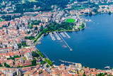 Como city, lake Como, Italy. Aerial view of Como and its lakeside on a beautiful summer day. The port, the public gardens and the train station are visible