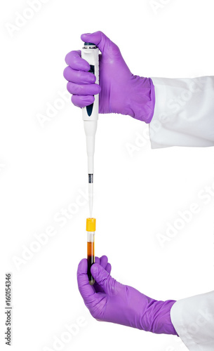 Doctor using pipette for blood sample examination