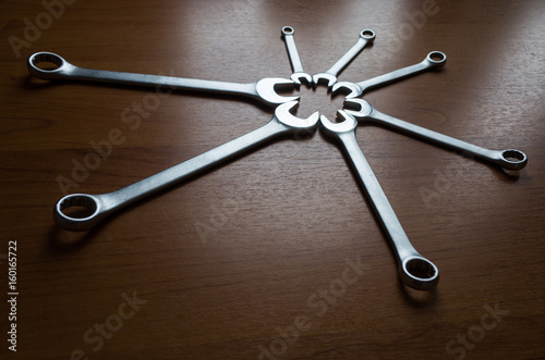 Set of metal wrenches on a wooden background. © fifg