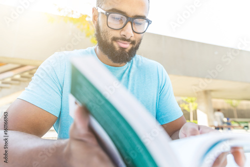 Photography Black man reading a book in the city