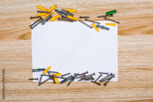 wire, screw and empty sheet of paper. Studio shot on wooden background. Fathers day composition 