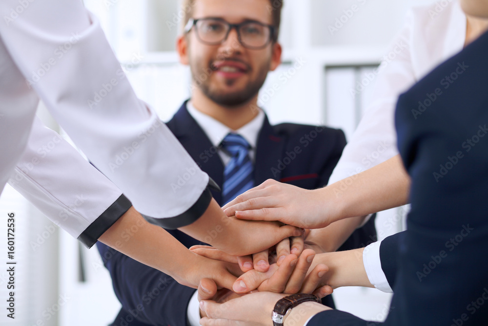 Business people group Business people group happy showing teamwork and joining hands or giving five after signing agreement or contract in office Business people group Business people group happy showing teamwork and joining hands or giving five after signing agreement or contract in office
