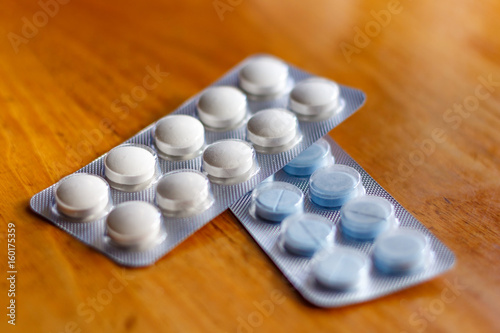 Tablets in a blister pack on a wooden table