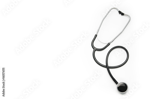 Stethoscope isolated on white background. Sterile doctors office desk. Medical accessories on a white table background with copy space around products. Photo taken from above.