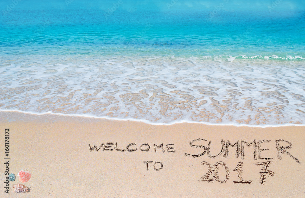 welcome to summer 2017 written on a tropical beach