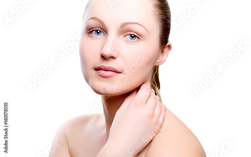 Portrait of girl with nude make-up with hand on neck isolated on white background. Girl with clean healthy skin on white. Cosmetology  medicine  beauty care. Nude makeup