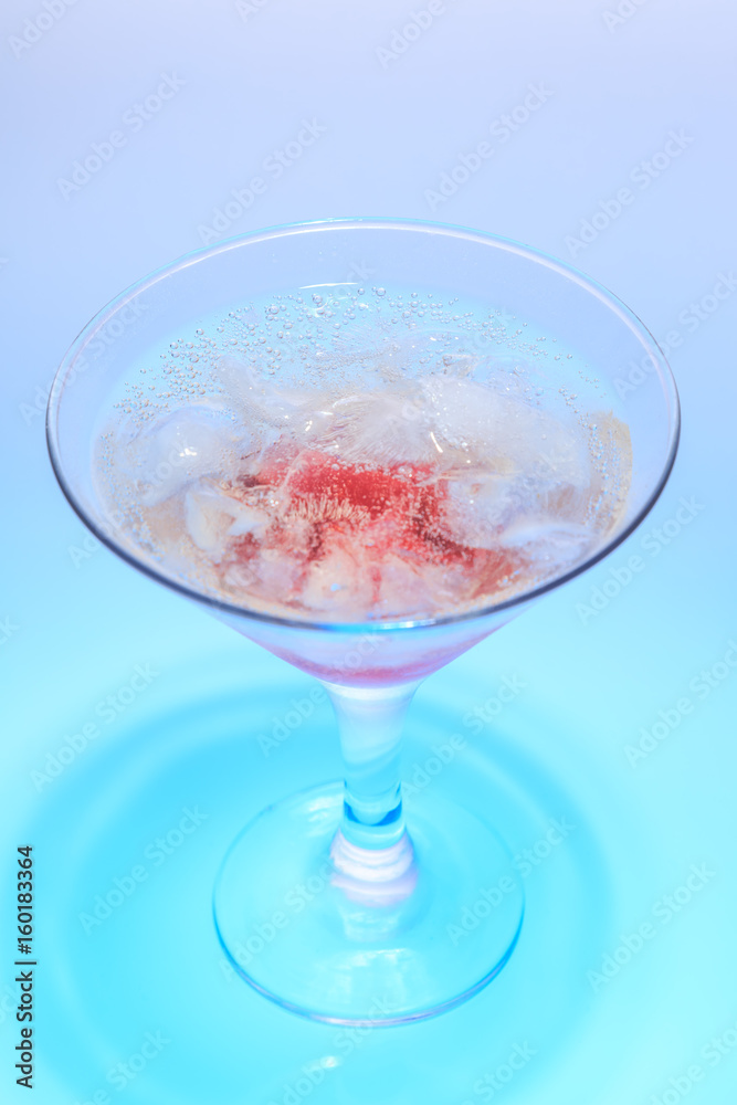 cocktail in a glass on a beautifully illuminated background cocktail in a glass on a beautifully illuminated background