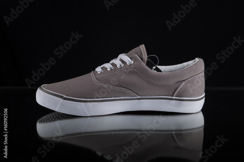 Male Grey Sneaker on Black Background, Isolated Product, Top View, Studio.