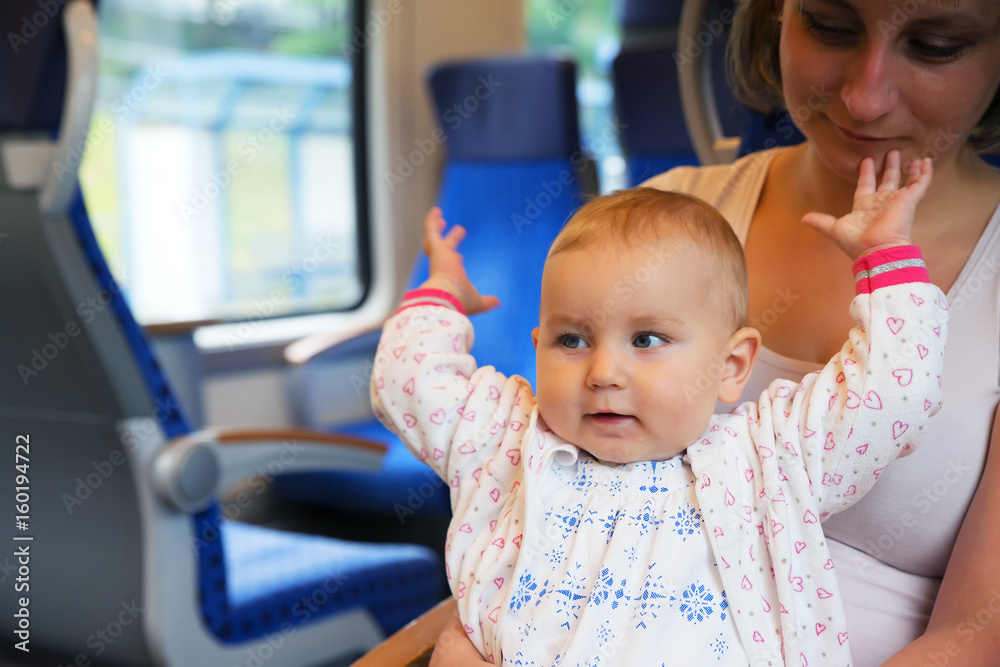 Little cute baby with blue eyes, traveling in a train Little cute baby with blue eyes, traveling in a train