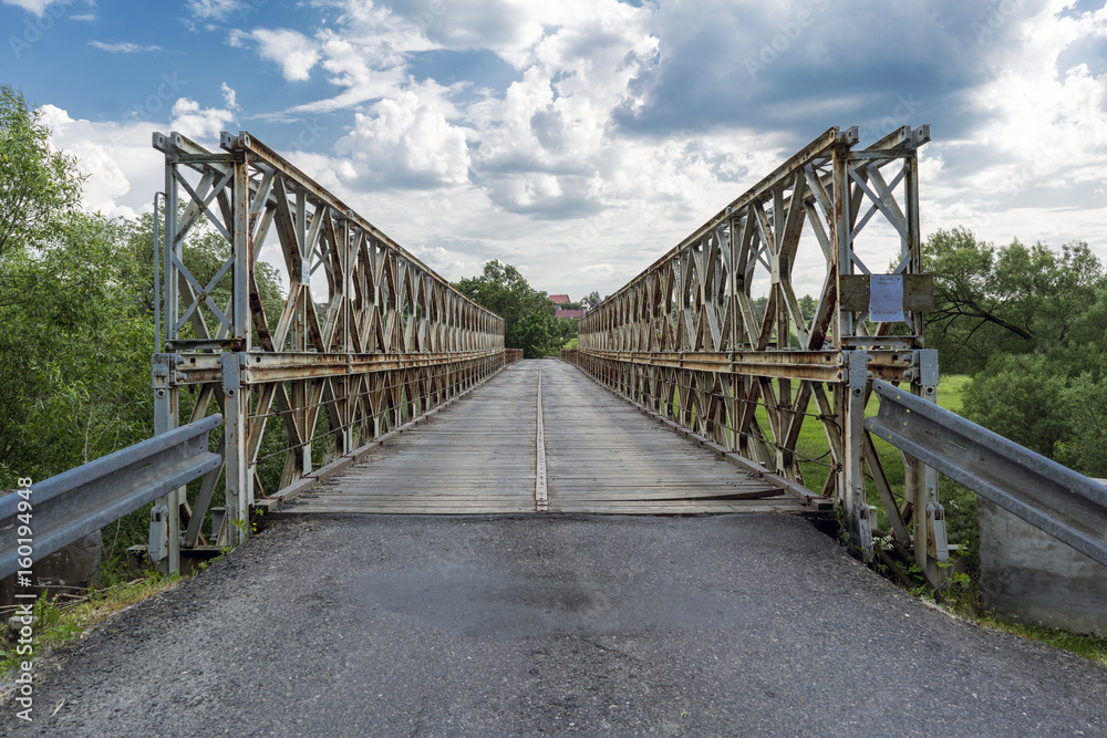 Old metal military bridge on the entrance road to the village of Kacov, Czech Republic