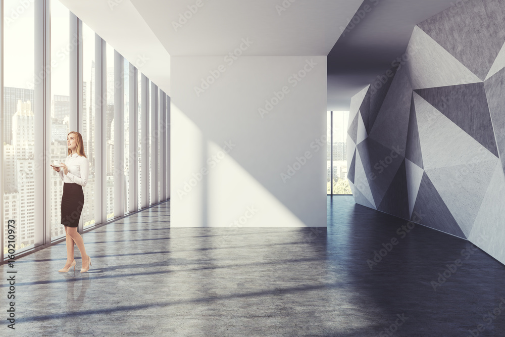 Blond in an empty office lobby