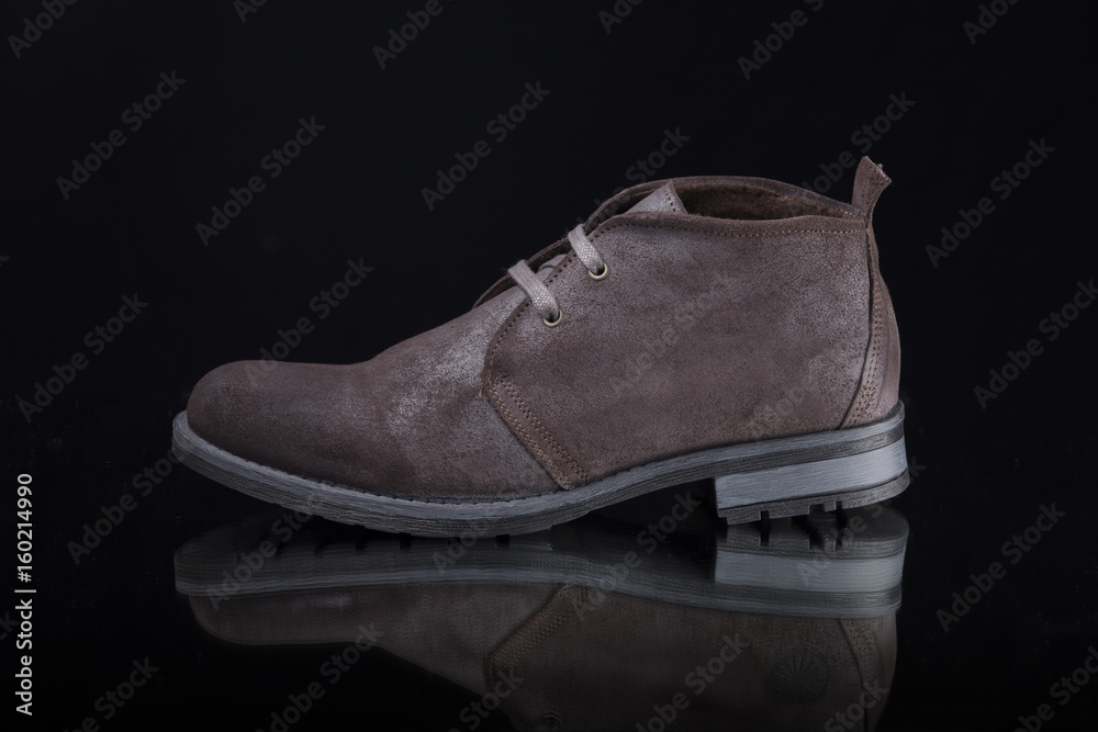 Male Brown Boot on Black Background, Isolated Product, Top View, Studio. Male Brown Boot on Black Background, Isolated Product, Top View, Studio.