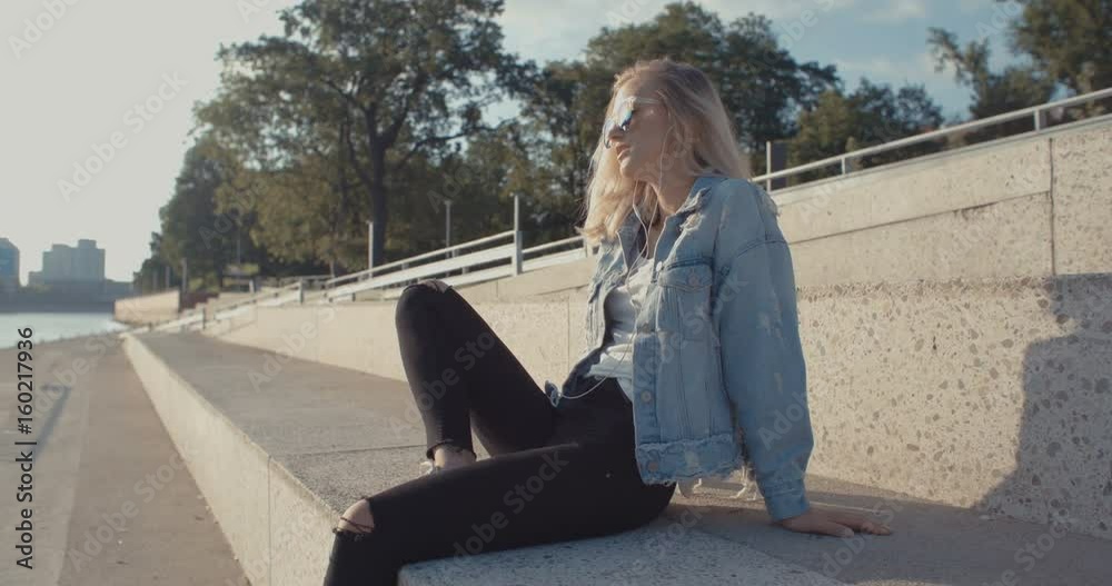 Young woman with headphones enjoying time in a city. Young woman with headphones enjoying time in a city.