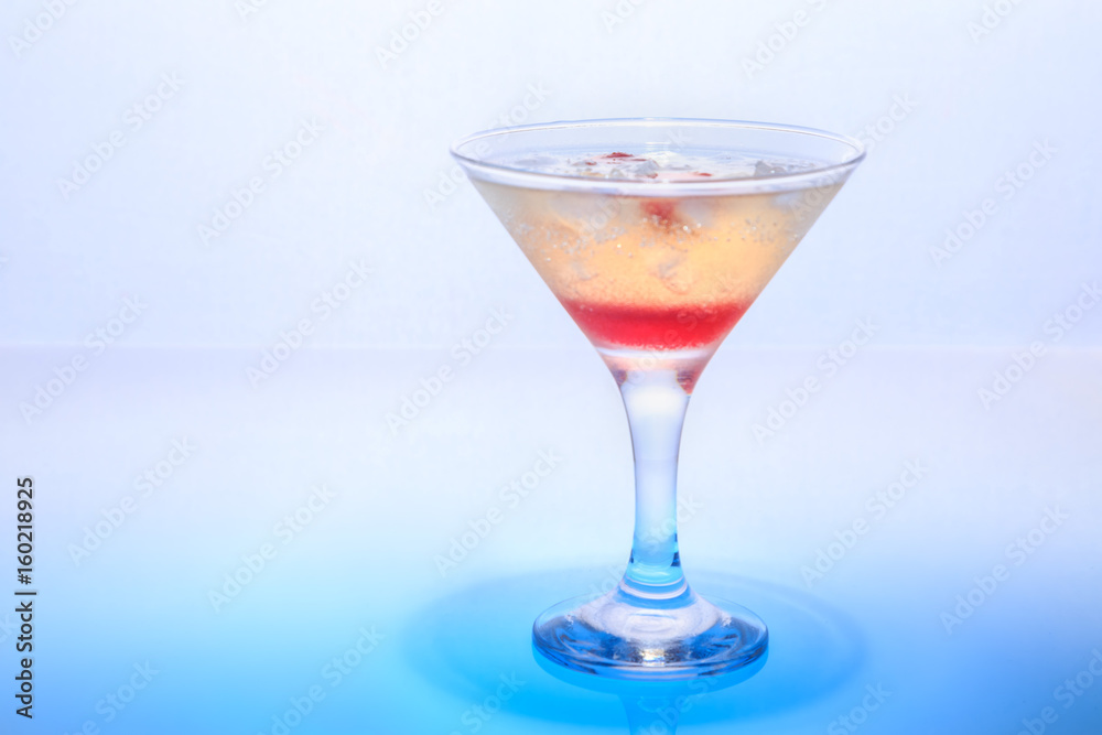 cocktail in a glass on a beautifully illuminated background cocktail in a glass on a beautifully illuminated background