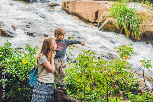 Mother and son on the background of Beautiful Camly waterfall In Da Lat city photo