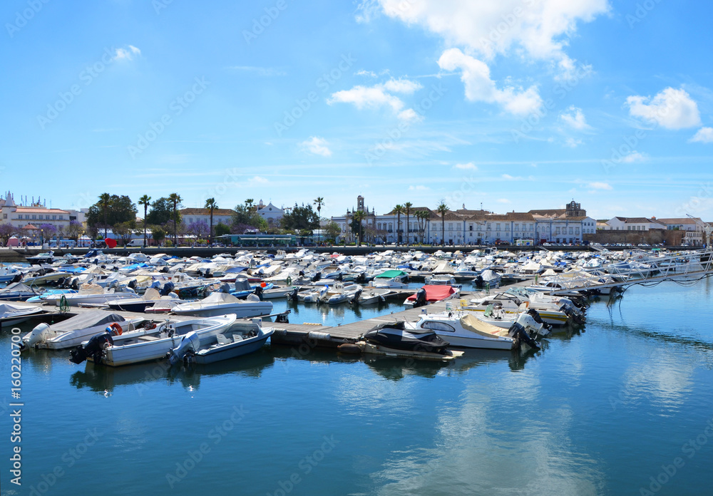 Boats at the marina of Faro with water reflection of clouds, Algarve, Portugal