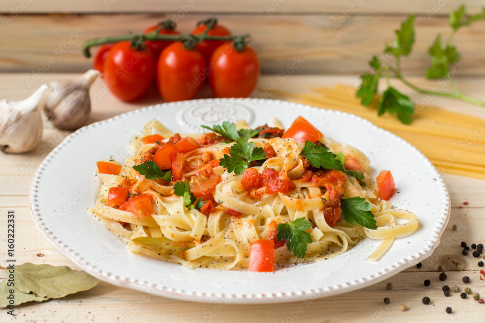Pasta on plate with tomatoes and garlic