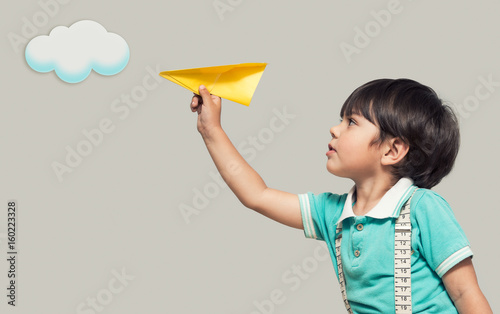 The boy is launching a paper plane