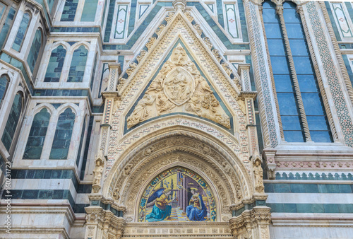 Porta della Mandorla, located on north side of cathedral in Florence. Door takes its name from almond-shaped motif, which contains image of Virgin of Assumption. Marble bas-relief by Nanni di Banco  photo