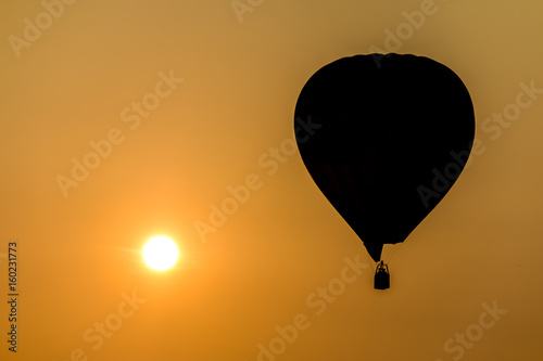 Silhouette of hot air balloon against sunset