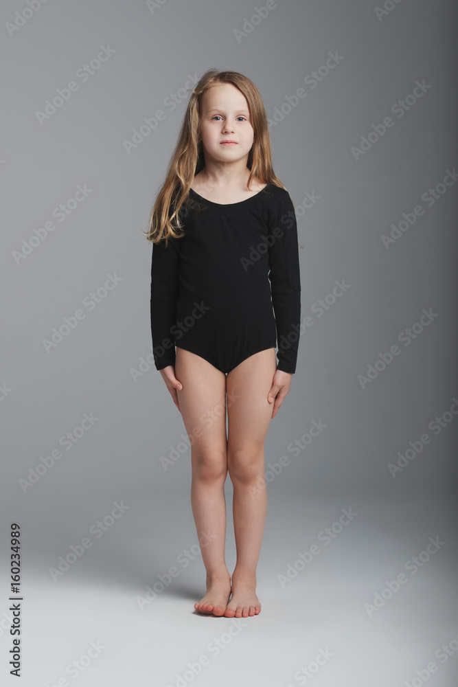 little girl studio portrait on grey background